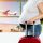 Pregnant woman tourist waiting at the airport hall with suitcase