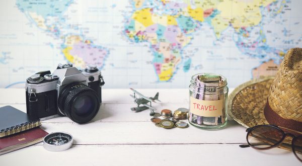 Collecting money for travel with accessories of traveler, Travel concept