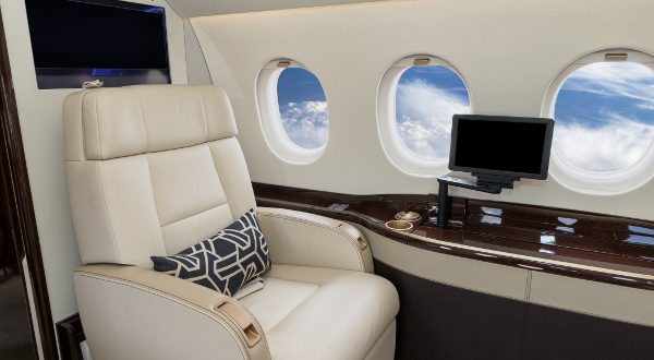 Comfortible cabin chair in a modern business jet during flight.